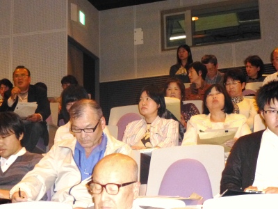 会場を撮影した写真。マイクを手に発言する参加者が写っている。